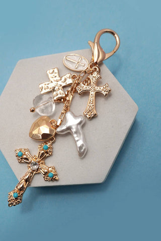 BAG CHARM- WESTERN HEARTWestern Bag Charm – Pearlized Cross With Heart & Stone DetailsPEARLIZED CROSS | 80K040